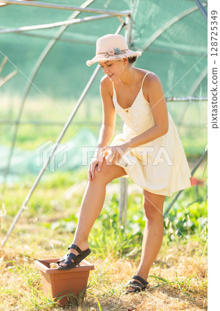 Female rural worker uses sunscreen Female rural worker uses sunscreen 128725349