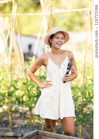 Young woman posing in garden in countryside 128725366