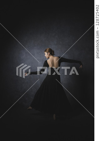 Woman posing against black background 128725402