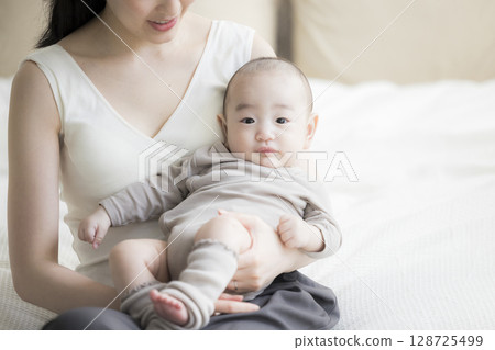 Mother holding a baby Mother holding a baby 128725499