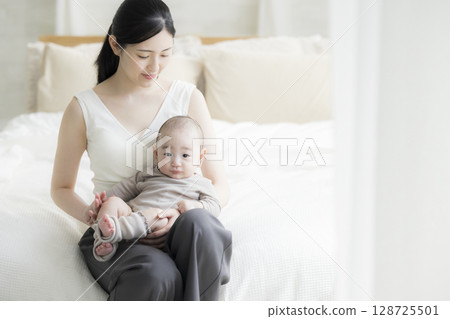 Mother holding a baby Mother holding a baby 128725501
