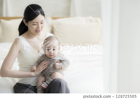 Mother holding a baby Mother holding a baby 128725505
