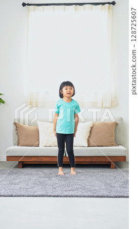 Girl standing in room Girl standing in room 128725607