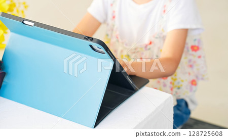 Girl using tablet in classroom Girl using tablet in classroom 128725608