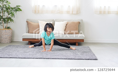 Girl exercising in the room 128725644
