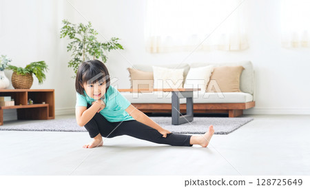 Girl exercising in the room Girl exercising in the room 128725649