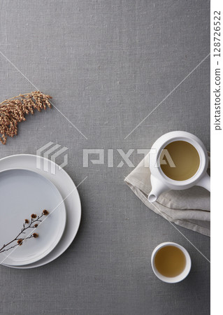 Elegant Korean table setting with traditional Korean bojagi gift wrapping for Chuseok, ceramic vase and fabric, tree branches. 128726522