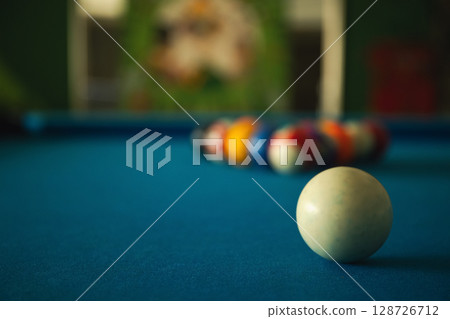 A player prepares to break on a neatly arranged pool table A player prepares to break on a neatly arranged pool table 128726712