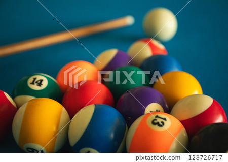 Billiard balls are arranged for a game on a blue felt table 128726717