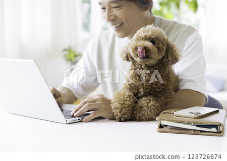 Telework: A dog being held by its owner 128726874