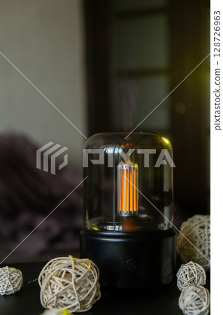 Indoors Decoration with modern lighted Air Humidification Aroma essential oil perfume fragrance. Scented home wellness wellbeing habit. Concept of feeling good spiritual health 128726963