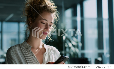 Businesswoman making a video call in the office 3 128727048