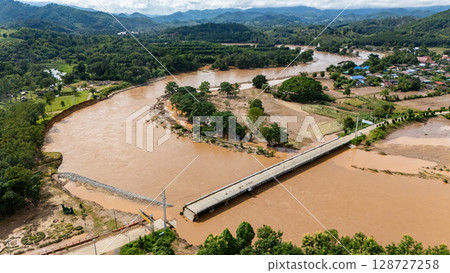 Aerial view of a broken bridge in Doi Hang subdistrict after Typhoon Yagi has swept Chiang Rai province of Thailand. 128727258