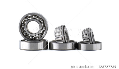 Set of ball bearings and roller bearings standing and laying on white background Set of ball bearings and roller bearings standing and laying on white background 128727785