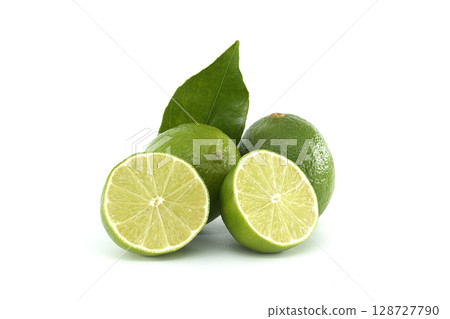 Fresh limes with leaf and two halves showing pulp on white background 128727790