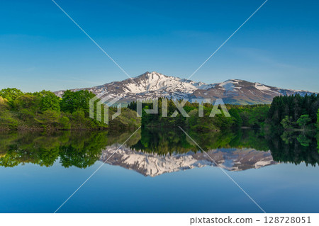 Mt. Chokai with snow remaining reflected in the water 128728051