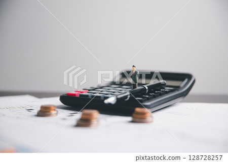 Financial calculate accountant blur background close up on calculator with graph chart banner bank office desk. Finance Concept tax banking money expense accounting budget businessman use calculator. Financial calculate accountant blur background close up on calculator with graph chart banner bank office desk. Finance Concept tax banking money expense accounting budget businessman use calculator. 128728257