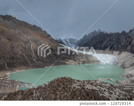 Aerial view of beautiful hanging glacier in high altitude mountains landscape 128728314