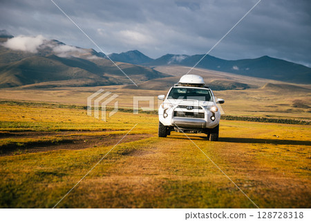 Driving Toyota off road car on the high altitude grassland mountains Driving Toyota off road car on the high altitude grassland mountains 128728318