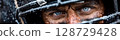 serious face of a male American football player in a sports protective helmet 128729428