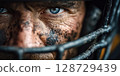 serious face of man American football player in a sports protective helmet 128729439