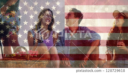 Chatting friends wearing outfits on patio drinking beer, with picnic basket, American flag overlay Chatting friends wearing outfits on patio drinking beer, with picnic basket, American flag overlay 128729618