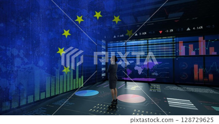 Observing executive in suit analyzing data in command center, with monitors, floor projections 128729625