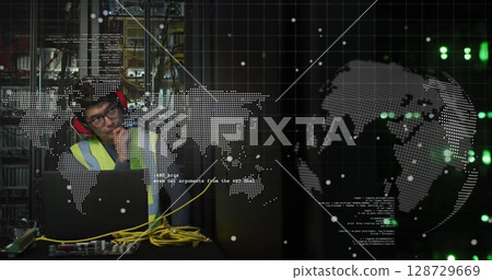 Inspecting technician in vest earmuffs checking laptop near server racks in data center, copy space Inspecting technician in vest earmuffs checking laptop near server racks in data center, copy space 128729669