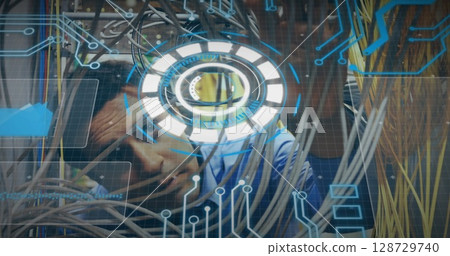 Hispanic man threading network cables in server room, with patch panels and holographic interface Hispanic man threading network cables in server room, with patch panels and holographic interface 128729740