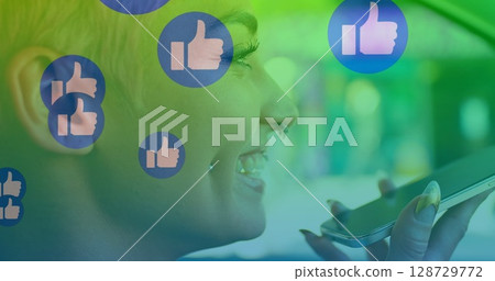 Smiling woman speaking into smartphone inside modern tech space, with virtual thumbs-up icons Smiling woman speaking into smartphone inside modern tech space, with virtual thumbs-up icons 128729772