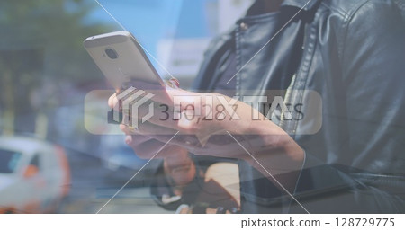 Holding smartphone, adult woman checking likes on city street, with 350,287 LIKES overlay Holding smartphone, adult woman checking likes on city street, with 350,287 LIKES overlay 128729775