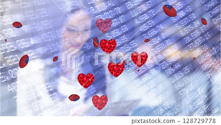 Colleagues studying stock data on glass display in office, with folder and floating heart icons 128729778