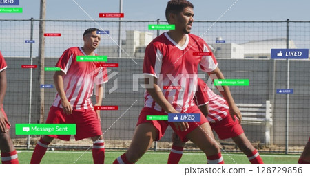 Training mid adult male player defending at artificial turf field, with social media overlays 128729856