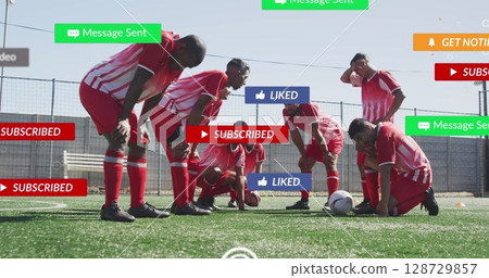 Social media concept icons against team of diverse tired male soccer players on sports field 128729857