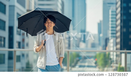 Portrait of a man holding a parasol Portrait of a man holding a parasol 128730387