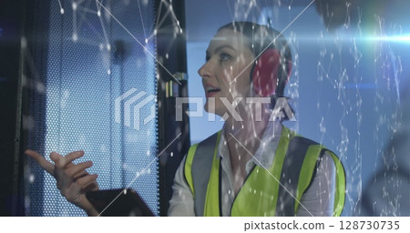 Image of connections over caucasian woman checking servers 128730735