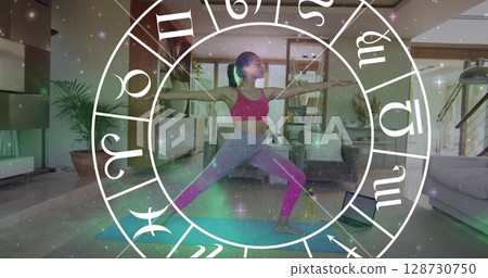 Circle of zodiac signs over women practicing yoga Circle of zodiac signs over women practicing yoga 128730750