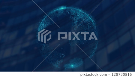 Image of spinning globe against tall building in background 128730816
