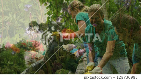 Image of flowers over diverse group of people collecting rubbish in forest 128730983
