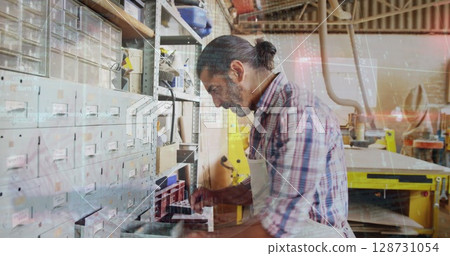Image of caucasian male carpenter working in workshop 128731054