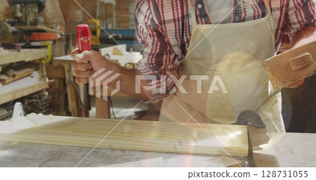 Image of data processing over caucasian male carpenter working in workshop Image of data processing over caucasian male carpenter working in workshop 128731055