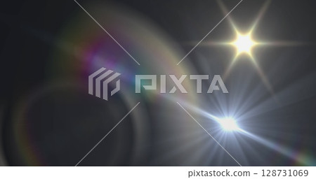Image of white light with beam and prismatic lens flare on dark background Image of white light with beam and prismatic lens flare on dark background 128731069
