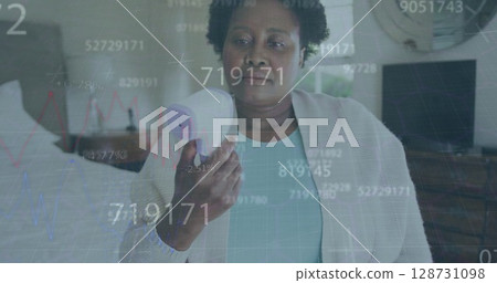 Multiple changing numbers over african american senior woman measuring her temperature at home Multiple changing numbers over african american senior woman measuring her temperature at home 128731098