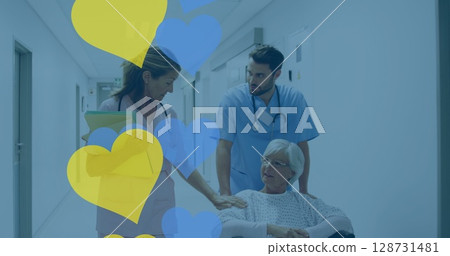 Pushing senior in wheelchair wearing hospital gown down corridor, with chart and heart shapes Pushing senior in wheelchair wearing hospital gown down corridor, with chart and heart shapes 128731481
