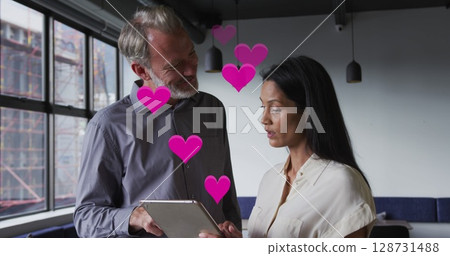 Image of digital icons over businesspeople using tablet 128731488