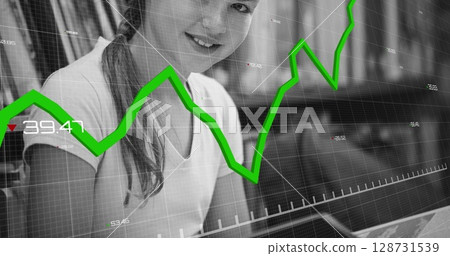 Image of financial data processing over reading caucasian girl 128731539