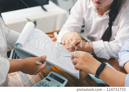 People meeting using laptop computer, calculator, stock market chart paper for analysis plans to improve quality. Team working on project. Analysis business brainstorming corporate smart Concept. 128731735