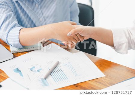 People meeting using laptop computer, calculator, stock market chart paper for analysis plans to improve quality. Team working on project. Analysis business brainstorming corporate smart Concept. 128731737