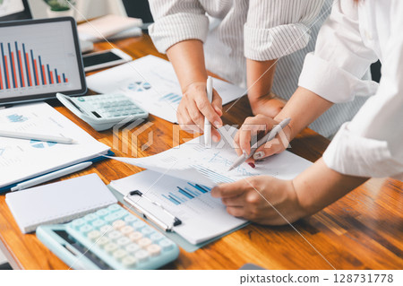 Financial business team in office, financial expert analyze business report graph and finance chart at corporate office. Concept of finance economy, banking business and stock market research. Financial business team in office, financial expert analyze business report graph and finance chart at corporate office. Concept of finance economy, banking business and stock market research. 128731778