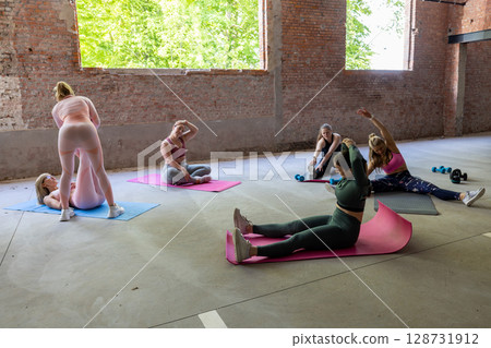 Join us for an invigorating Group Yoga Session in our Bright Studio filled with Natural Light 128731912